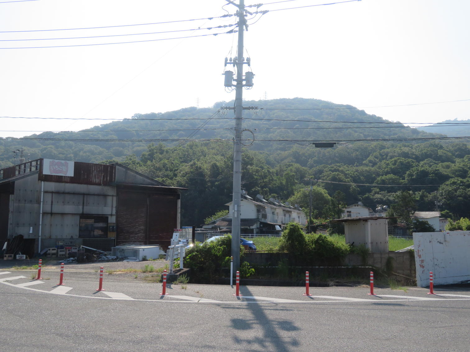 倉庫の建物と、その奥の住宅。